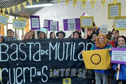 Argentinean intersex group poses for a photo with posters and signs